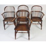 A set of four Windsor armchairs, 19th century, each with a stick filled back, solid arms and seat,