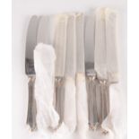 A set of eight Mappin and Webb table knives with stainless steel blades and filled silver handles,