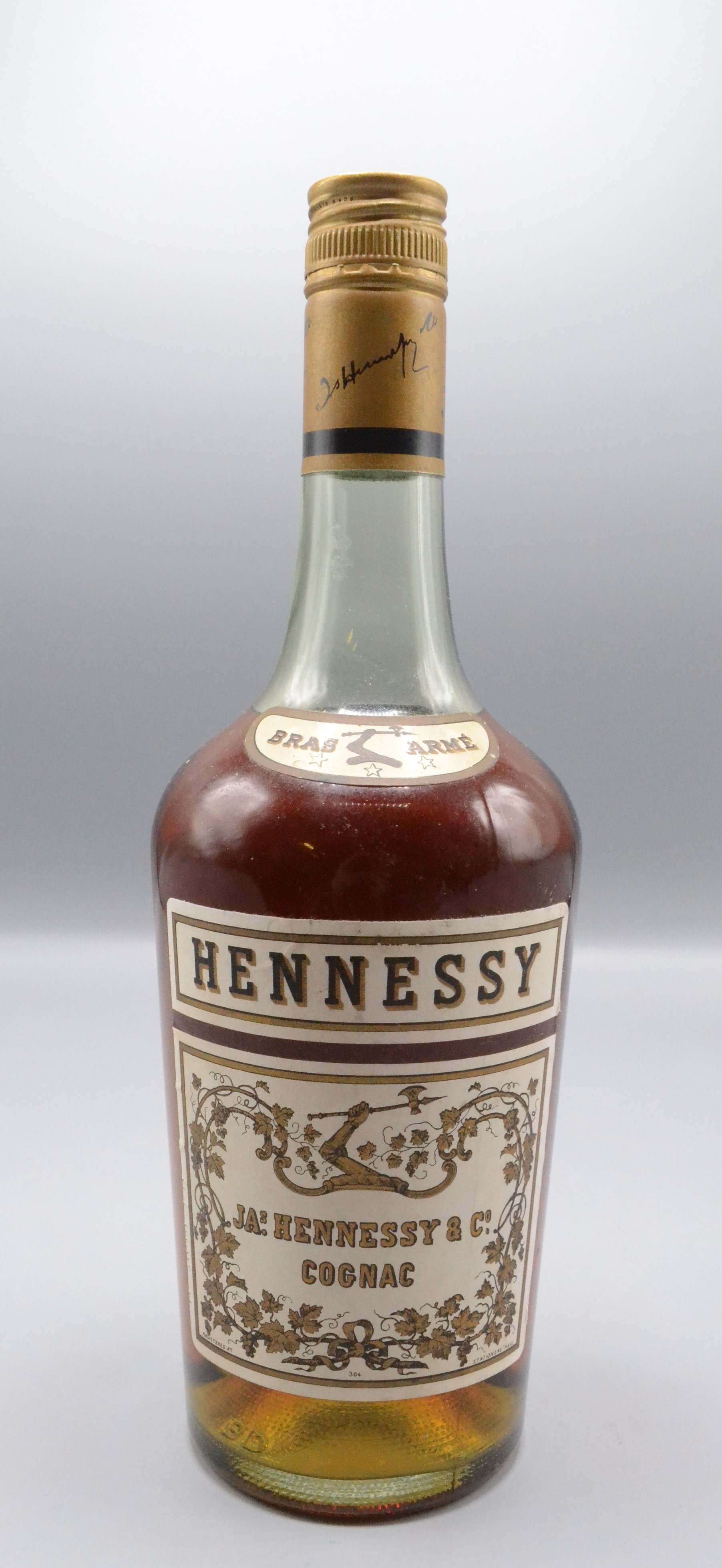 A bottle of JAs. Hennessy & Co Bras Arme Cognac, height 28cm.