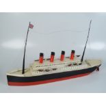 A tin plate model of RMS Mauretania, height 47cm, length 82cm, width 17cm.