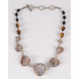 A contemporary Arts and Crafts necklace set with agate panels.