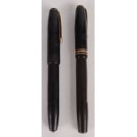 Two fountain pens, each with gold nib.