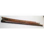 A silver topped bamboo walking cane, length 85cm and five others.