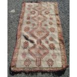 A North West Persian rug, the beige field with four linked medallions and hooked guls,