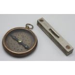 A metal cased compass by T.