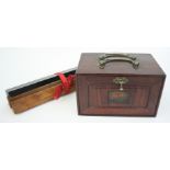 A Chinese hardwood mahjong set, the cabinet surmounted with a pair of brass swing handles,