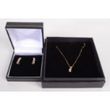 A 9ct gold diamond set pendant on gold chain and a pair of 9ct gold earrings each set a line of