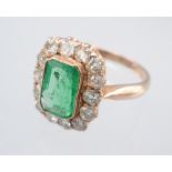 An emerald and diamond ring the principle rectangular stone of approximately 1.68cts.