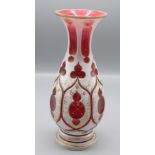 A Bohemian cranberry and white overlaid glass vase, 19th century, with gilt decoration, height 27.