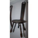 A late Victorian oak spinning chair, the back carved with a grotesque mask, on turned supports,