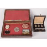 A box for six thimbles, together with a silver button hole insert and a box containing brooches etc.