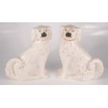 A pair of Victorian Staffordshire pottery spaniels, height 31cm, width 28.5cm.