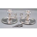 A pair of Sheffield plated chamber candlesticks, one lacking snuffer.