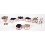Five silver condiments, a silver egg cup and two silver napkin rings, 6.7oz.