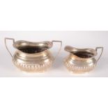 A half fluted silver sugar bowl with gadrooned rim and a matching milk jug, Birmingham 1911, 5.9oz.