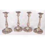 A set of four George IV Sheffield silver plated candlesticks, height 25cm, diameter of base 13.5cm.