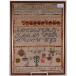 A woolwork alphabet sampler by Grace Kistle Martin aged 10, also decorated with plants,