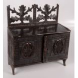 A Black Forest carved wood wall cabinet, 19th century,