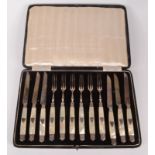 A set of six French late 19th century dessert knives and forks with silver blades and silver
