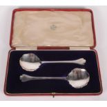 A pair of Edwardian silver serving spoons with shaped bowls and trefid finials, 4.
