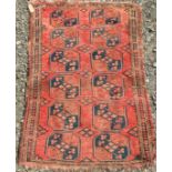 An Afghan rug, the madder field with six rows of two octagonal medallions within three borders,