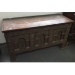 A carved oak coffer, late 17th/early 18th century, with a triple carved front,
