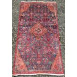 A Hamadan rug, the indigo field with a central polychrome medallion, guls and flowering vines,