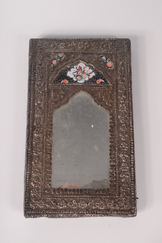A Persian enamelled silver mounted mirror.