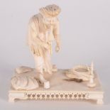 An Indian ivory figure of a snake charmer, 19th century, standing on a rectangular plinth base,
