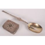 A small silver replica of the anointing spoon and a small silver box,