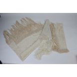 Two cream silk, embroidered, fringed shawls, decorated with floral sprays,