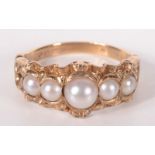 A 9ct gold ring, set with pearls in Victorian style.