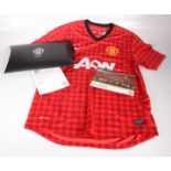 A Manchester United signed football shirt, sponsored by Aon,