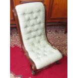 A Victorian button salon chair with mahogany frame and turned legs.