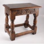 A small carved oak joint stool in 17th century style.