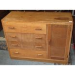 An Arts and Crafts oak side cabinet, with retailer's label by Lee Longland & Co. Ltd, Broad St.
