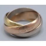 An 18ct gold Cartier Trinity ring, one ring signed Cartier, size Q, 17g.