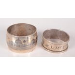 An Iraqi silver niello enamelled napkin ring and one other silver napkin ring.
