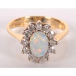 An 18ct gold diamond and opal ring.