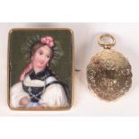 A Victorian engraved gold mounted oval locket with hinged cover to the front and back,
