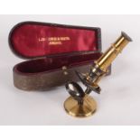 A miniature brass microscope, inscribed 'Lawrence & Mayo, London',