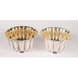 A pair of Bulgari silver petal fluted cups, each inscribed 'London 1988', each with gilt interior,
