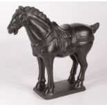 A hardstone model of a Tang horse, incised mark to base, height 24cm, length 27cm.