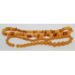 Two 'amber' necklaces 79g.