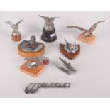 A collection of car mascots and insignia, including an Armstrong Siddeley modelled as a sphinx,