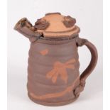 A Peter Smith stoneware lidded jug with slip floral decoration, seal marks, height 17.5cm.