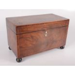 A George III mahogany tea caddy, with a fitted interior on bun feet, height 18cm, width 29cm,