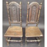 A pair of carved oak 17th century style high back chairs.