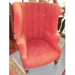 A mahogany high back wing armchair, 19th century, with a ribbed back and spade feet, height 114cm,