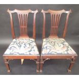 A pair of unusual 18th century mahogany dining chairs in Chippendale style,